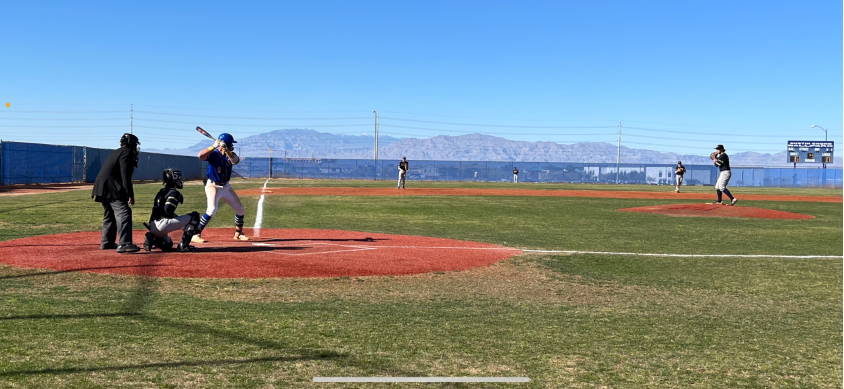 Varsity baseball third baseman, James Starkus (12), steps up to bat during an intense home game against Spring Valley High School.
