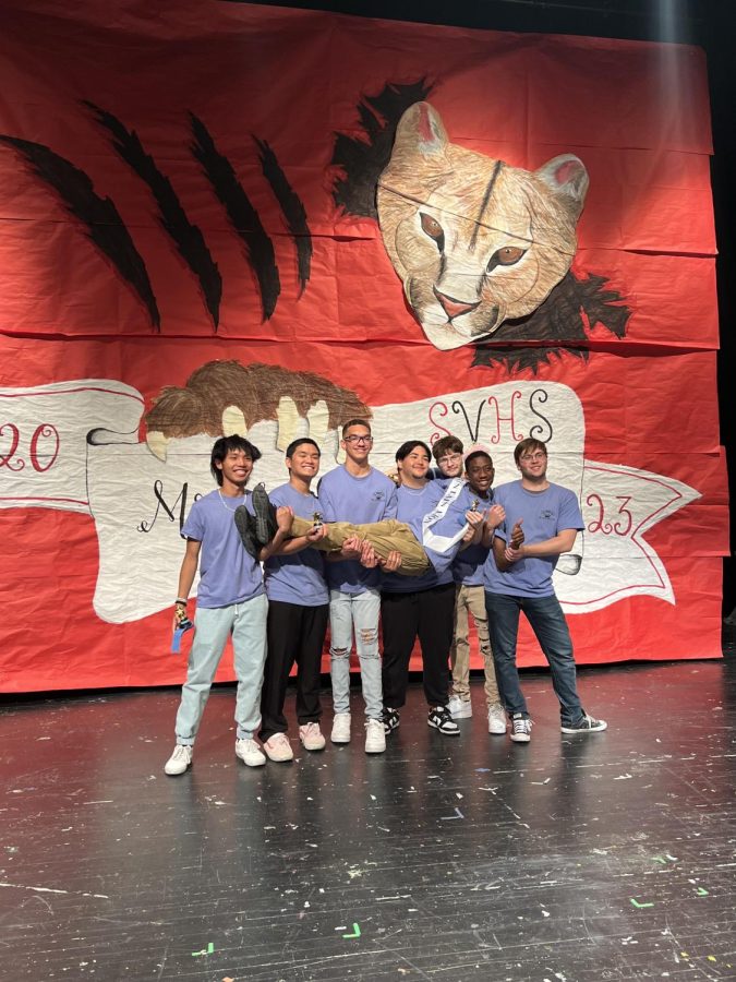 On Thursday, April 20, 2023, the 19th annual Sierra Vista High School pageant event, Mr. Mountain Lion, featured seven male members of the senior class in a contest of their charisma and stage presence. From left to right, Ralph Pedraza (Mr. Photogenic), Nathan Cuyugan (Mr. Betty Crocker), Carson Baxter, Xavier Santos, Dakota Miller (Mr. Charming), and Teagan Thomson, hold up Maurice Carney, the winner of Mr. Charitable and Mr. Mountain Lion.