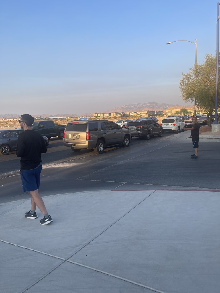 Campus security officers Brett Terry and Martin Ruelas guide parents at drop-off while ensuring only student drivers enter the parking lot.