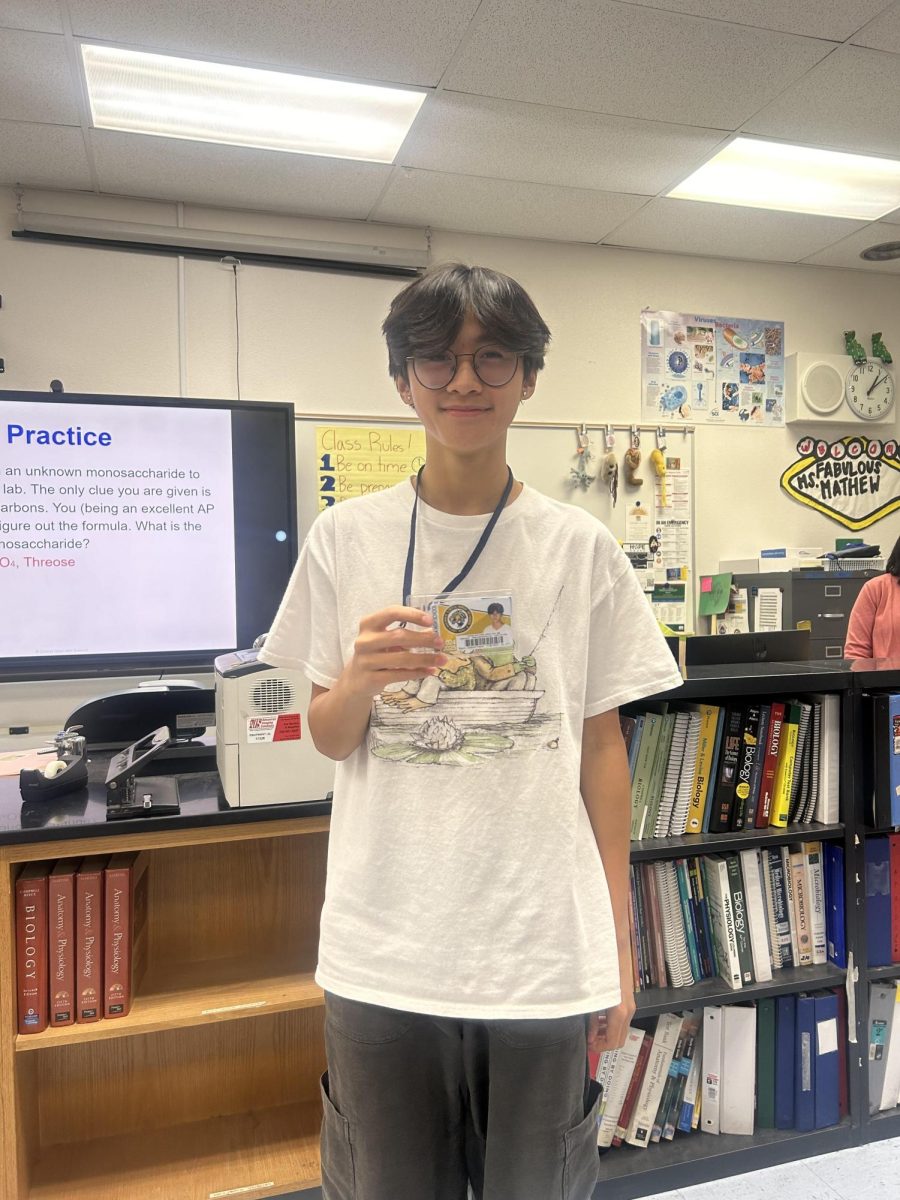 Gabriel Sison (11) proudly displays his ID badge around his neck in the proper way to wear it.