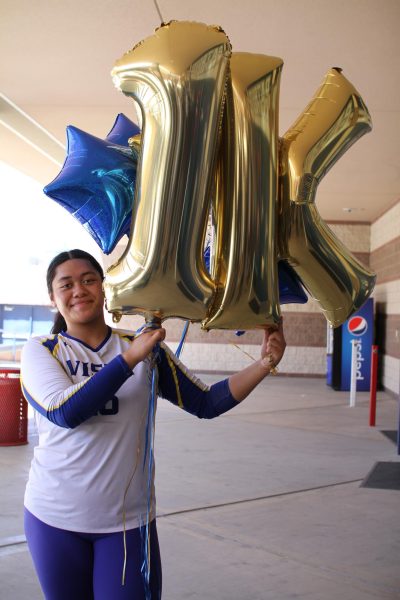 Nothing but smiles for Ariella Maika (12) as she holds up her “1K” balloons celebrating her 1,000th high school career kill.