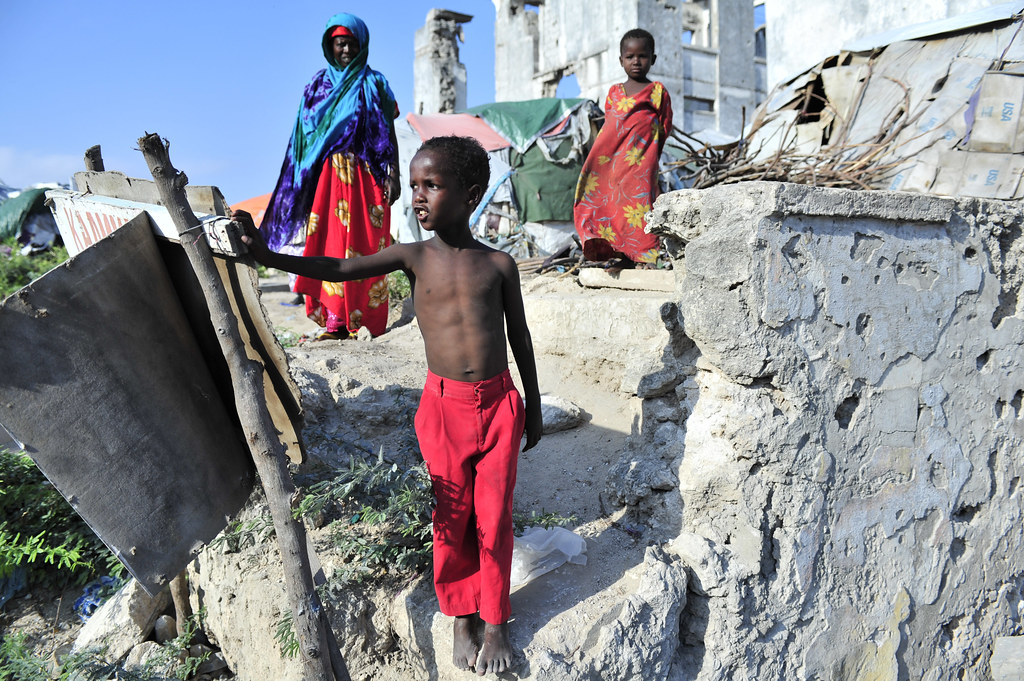 City Rubble. A Somali boy standing atop rubble in Somalia's capital, Mogadishu. (Taken on November 18, 2012 by Tobin Jones for Flickr Creative Commons License)