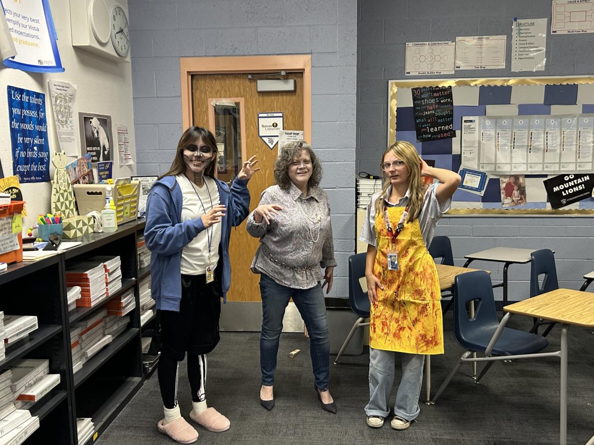 Arissa Garcia (11), Ms. Fick, and Farah Ford (11) scaring the Journalism staff with their terrifying costumes.