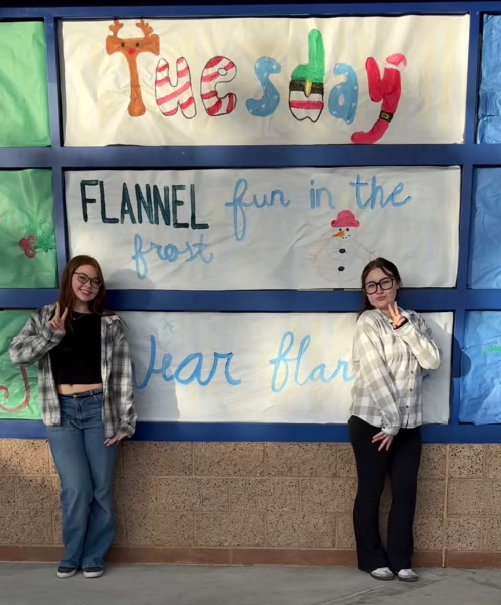 Bundled up in flannels, Makenzie Gidge (11) and Malia Bartlett (11) bring cozy vibes to Flannel Day during Winter Week.