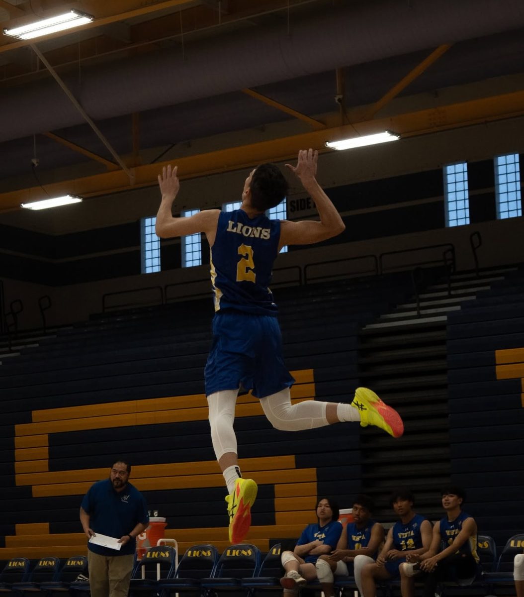 Team captain Regi Beshiri prepares to serve during a match at the Aggies Classic Tournament (Photo taken by Brayden Pahk 12).