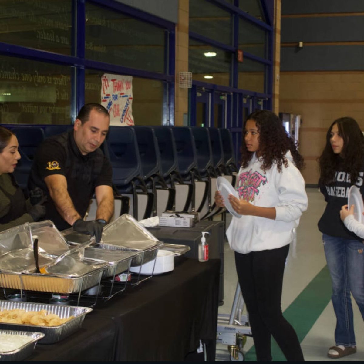  Janaya Hainey (11) engages with event staff during the first Hispanic Family Night, helping showcase HLSU’s commitment to community connection and cultural celebration.