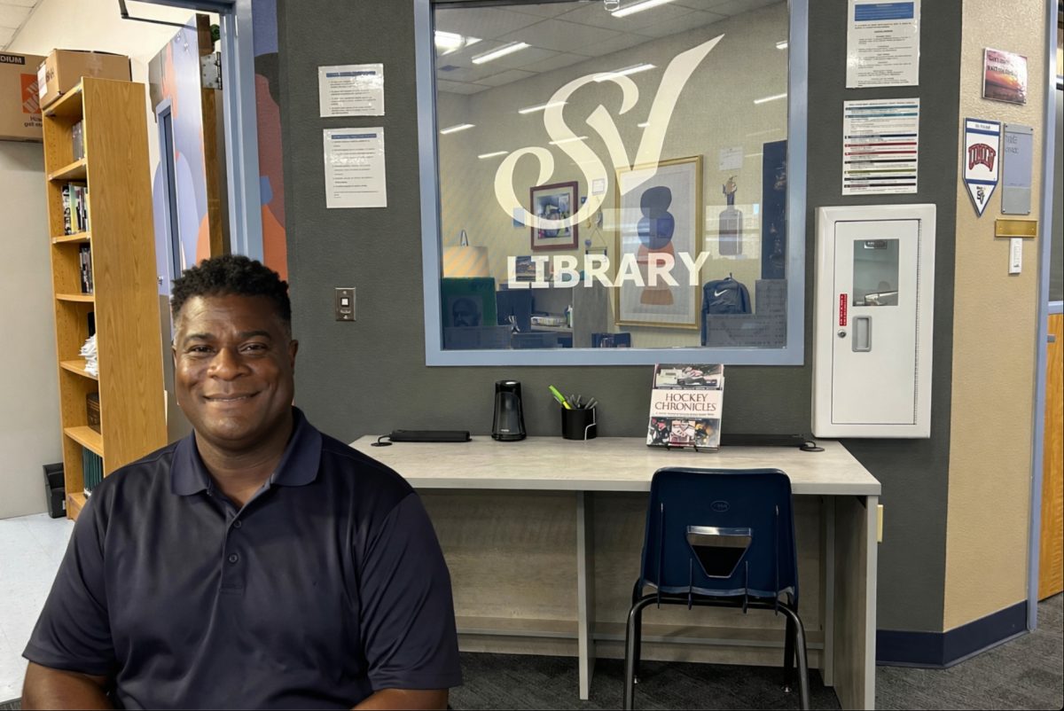 
Mr. Mitchell, library specialist, poses inside the Sierra Vista High School Library, highlighting the welcoming and modern space designed to support student learning and collaboration.