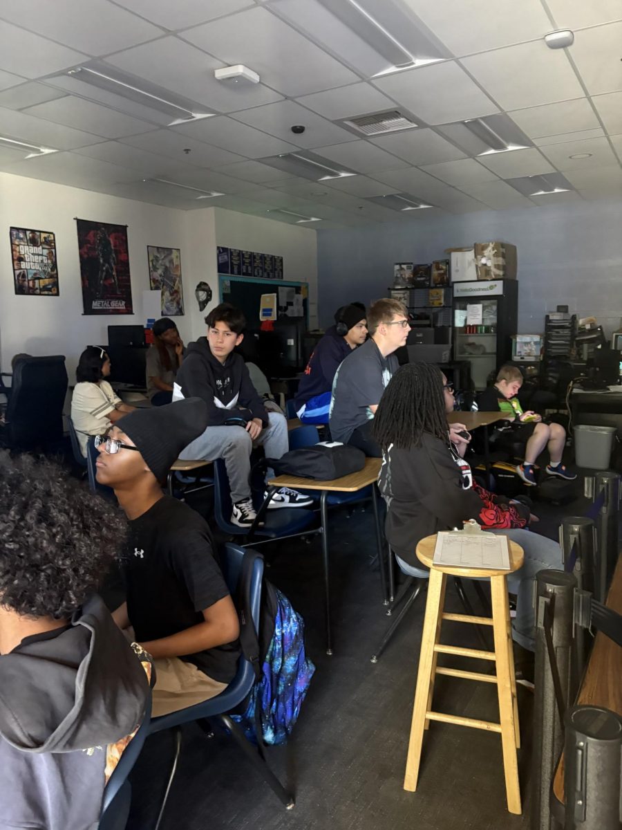 The members of Video Game Club gather to bond over their love for video games. Two members of Video Game Club fight against each other in a match of Super Smash Bros.