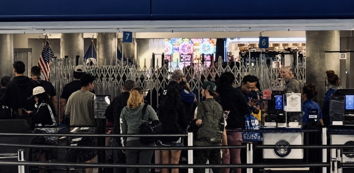 Travelers navigate Harry Reid Airport's security queues during the height of the 2026 federal funding
